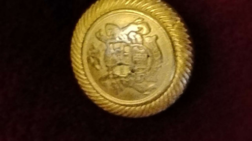 Gold-tone metal blazer button with heraldic shield and anchor motif