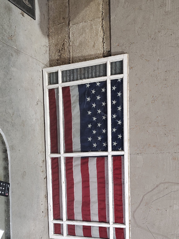 Wooden window frame with American flag display