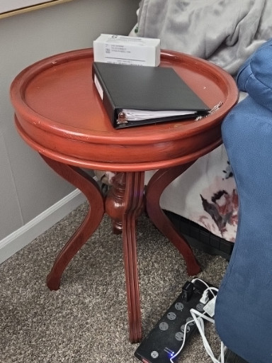 Wood round accent table in red finish