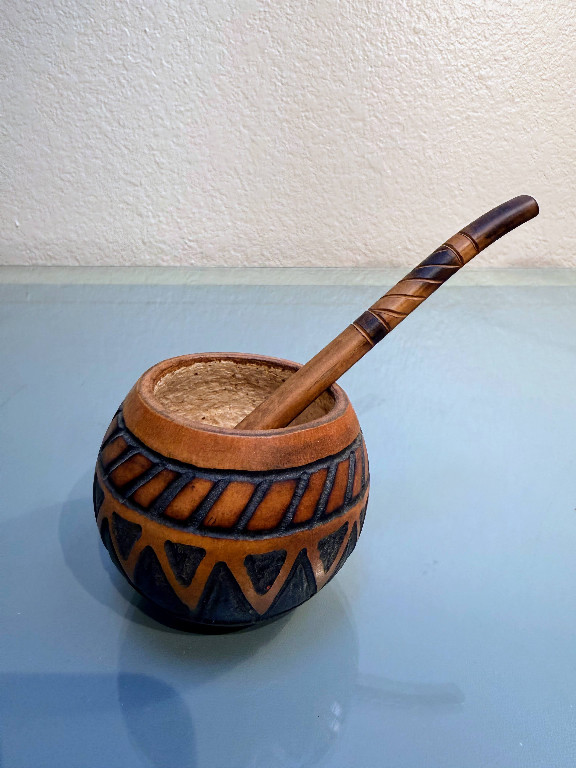 Carved wooden yerba mate gourd with bombilla (drinking straw)