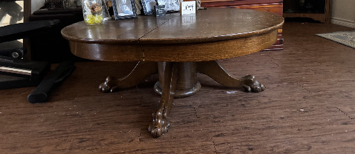 Oak round pedestal table with carved claw feet