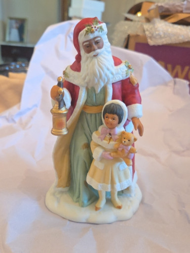 Porcelain figurine titled 'Santa with Girl and Teddy Bear' by Avon