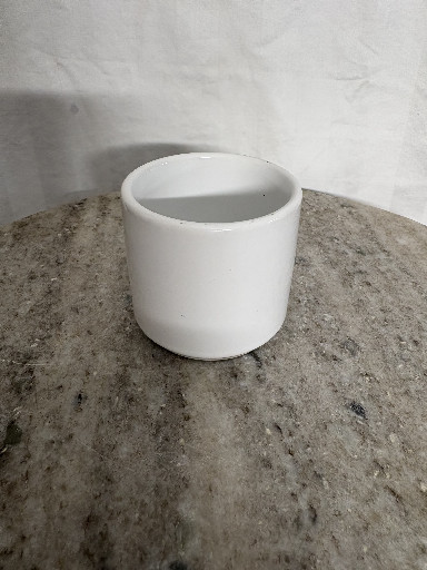 White porcelain or ceramic cylindrical cup or small vase