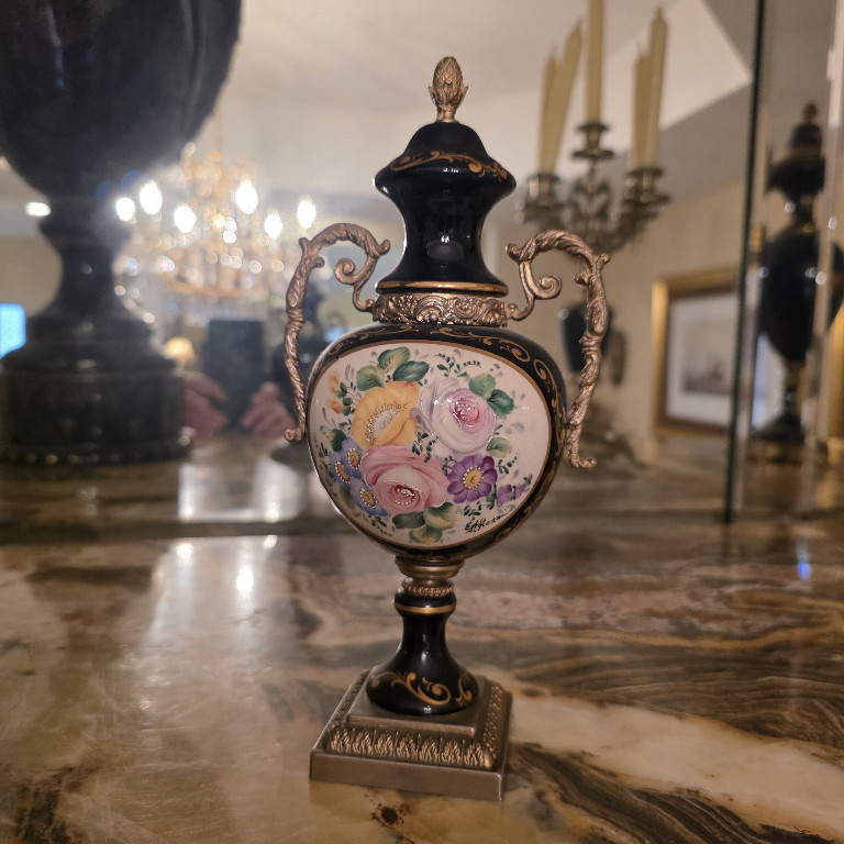 Porcelain lidded urn with hand-painted floral decoration and gilt bronze handles