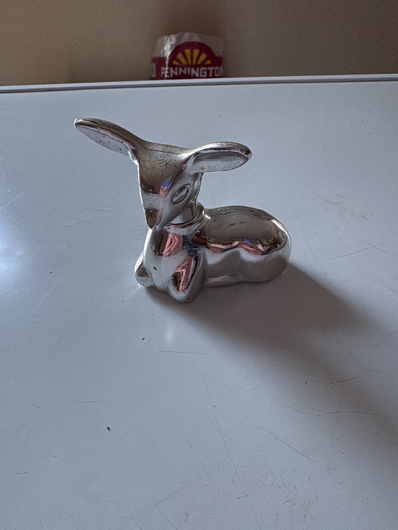 Silver-plated metal perfume bottle in the shape of a fawn by Avon