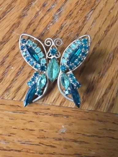 Vintage rhinestone butterfly brooch in aqua blue and clear crystals set in silver-tone metal