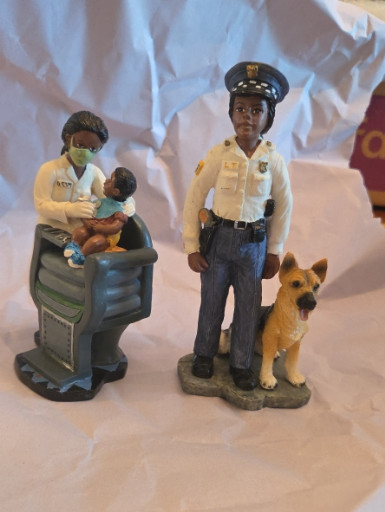 Resin figurines from Vanmark's 'Protectors of Peace' series, including 'Loyal Partner' with police officer and K-9 dog