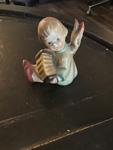 Porcelain figurine titled 'Angel with Accordion' by Goebel Hummel