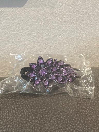 Rhinestone-embellished hair clip with purple crystal flower design