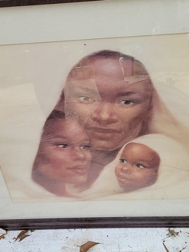 Framed print or poster depicting three African faces