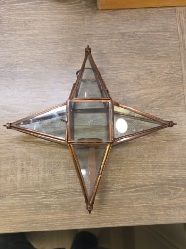 Brass and glass star-shaped hanging tealight candle holder