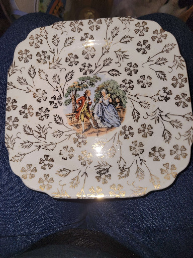 Ceramic decorative plate with courting couple scene by Atlas China, warranted 22-karat gold trim