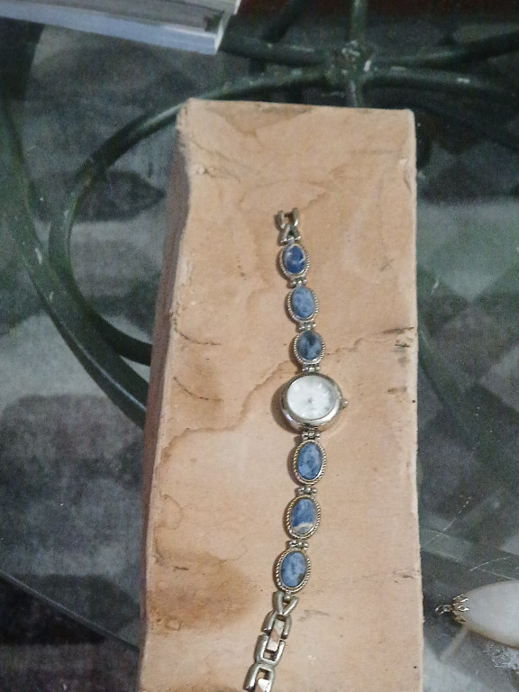 Silver bracelet watch with mother-of-pearl dial and blue gemstone links