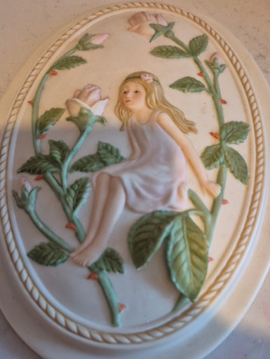 Fine bisque porcelain wall plaque titled 'Fairy on a Rose Bud Branch' by Alexander, 1988 Collection
