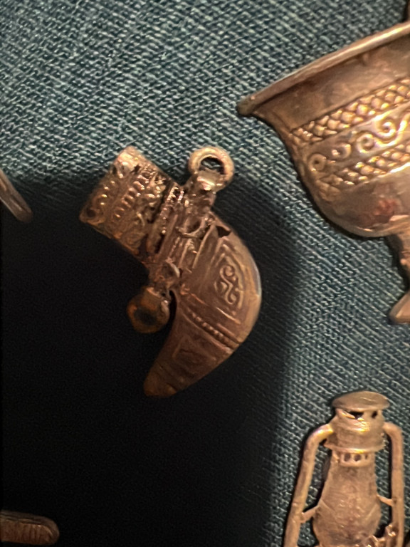 Bronze decorative dagger pendant with ornate detailing and inscriptions