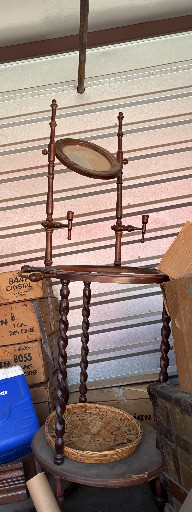 Victorian-style wooden washstand with barley twist legs and three-tier folding shelves