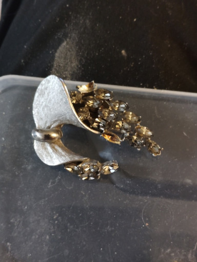 Vintage costume jewelry brooch with marquise-cut rhinestones on textured silver-tone metal, likely by BSK