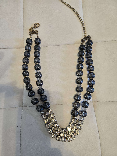 Multi-strand beaded necklace with dark blue/black glass beads and rhinestone cluster centerpiece by Chico's
