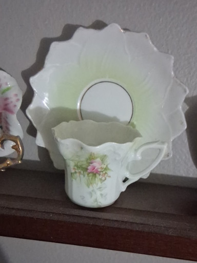 Porcelain demitasse cup and saucer with hand-painted pink roses