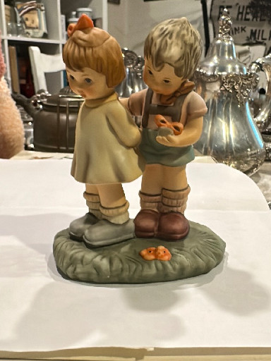 Porcelain figurine titled 'Token of Love' by M.I. Hummel