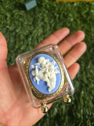 Sankyo music box with blue and white cherub cameo relief