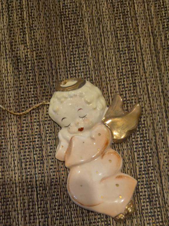 Porcelain angel figurine with gold accents