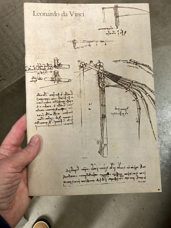 Paper print reproduction of Leonardo da Vinci's mechanical drawings and notes