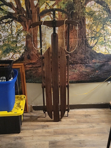 Vintage wooden snow sled with metal runners titled 'Lightning Guider No. 125'