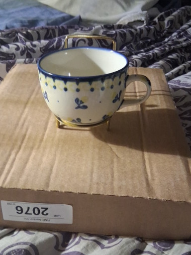 Ceramic coffee cup with hand-painted blue floral decoration