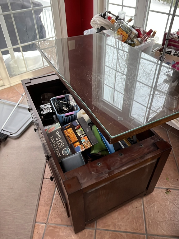 Modern wooden coffee table with lift-top storage and glass top