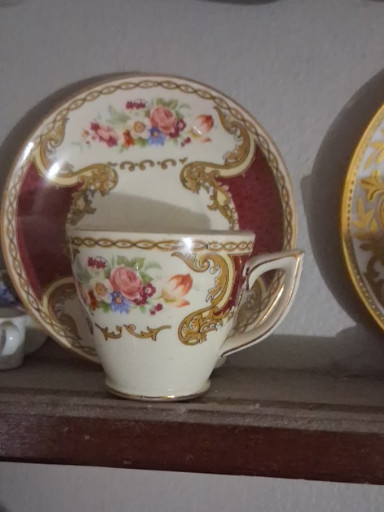 Porcelain demitasse cup and saucer set titled 'The Bouquet' by Myotts Royal Crown Staffordshire