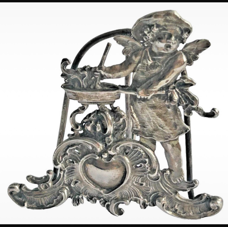 Sterling silver menu holder featuring a cherub figure, Continental