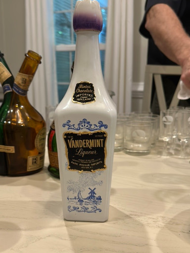 Milk glass liqueur bottle for Vandermint Dutch chocolate mint liqueur with Delft blue windmill design