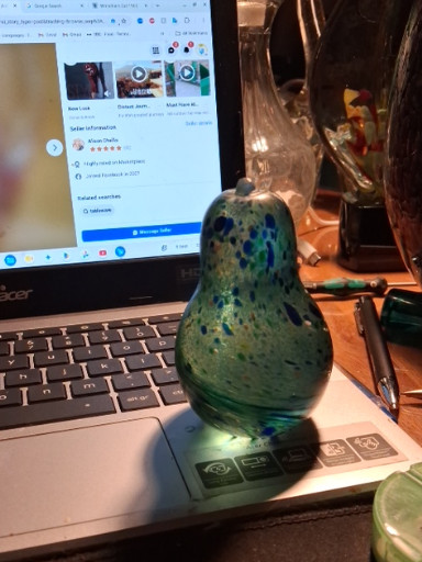 Art glass pear-shaped paperweight with blue-green speckled design