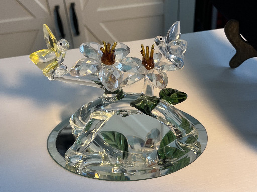 Crystal glass figurine featuring two hummingbirds with flowers on a mirrored base