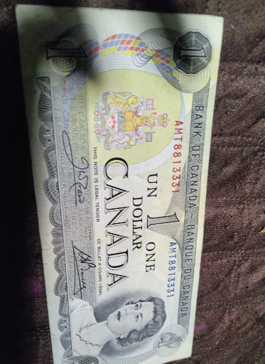 Canadian One Dollar banknote from 1973, issued by Bank of CanadaThe 1973 Canadian one dollar banknote was part of the 1954 Devil's Face series that continued into the 1970s, featuring Queen Elizabeth II on the obverse and a landscape scene on the reverse. These notes were signed by various combinations of Bank of Canada governors and deputy governors, with the Lawson-Bouey and Crow-Bouey signatures being among the most common for this year. The 1973 series represents the final years of the one dollar banknote before Canada transitioned to the iconic loonie coin in 1987, making these notes increasingly collectible as they are no longer in circulation. Paper currency collectors and Canadian numismatists are particularly drawn to these banknotes for their historical significance and connection to Canada's monetary evolution. Collectors value these notes based on condition, signature combinations, serial number patterns, and rarity, with uncirculated examples commanding premium prices in the marketplace.