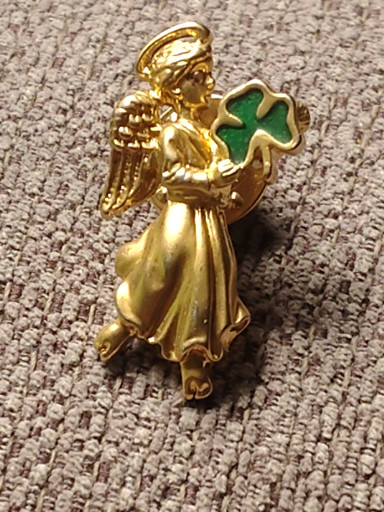 Gold-tone metal angel brooch with green enamel shamrock by Avon