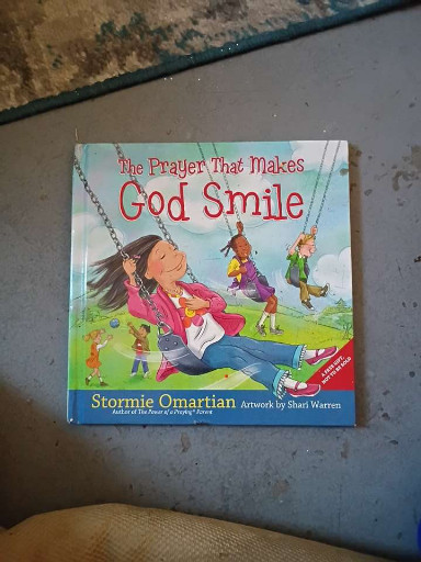 Children's hardcover book titled 'The Prayer That Makes God Smile' by Stormie Omartian