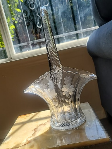 Pressed glass basket with applied handle featuring floral decoration