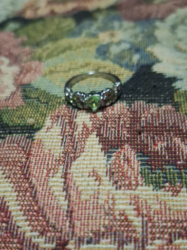 Sterling silver ring with peridot center stone and decorative setting