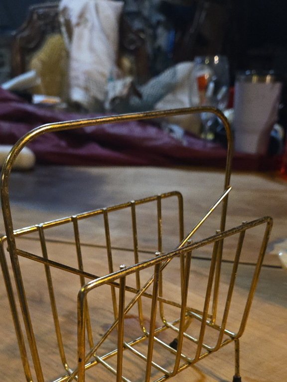 Brass magazine rack in mid-century modern style