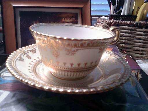 Porcelain cream soup bowl and saucer set with gold filigree decoration by Aynsley