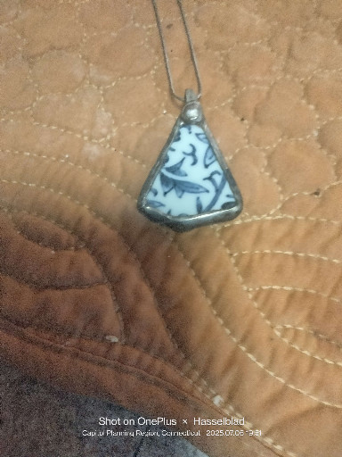 Porcelain pendant with blue and white floral design in silver frame