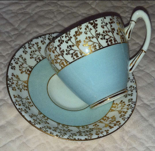 Fine bone china tea cup and saucer set with robin's egg blue glaze and gilt floral decoration by Gladstone