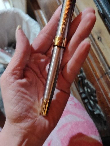 Stainless steel ballpoint pen with gold-tone trim by Jinhao