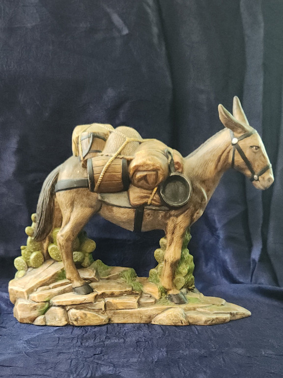 Ceramic figurine of a pack donkey with supplies.
