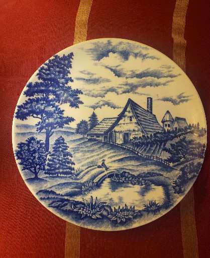 Ceramic decorative plate with blue and white hand-painted rural landscape scene, made in Japan