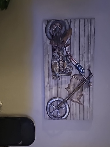 Metal sculpture of a motorcycle chopper made from recycled nuts, bolts, and mechanical parts