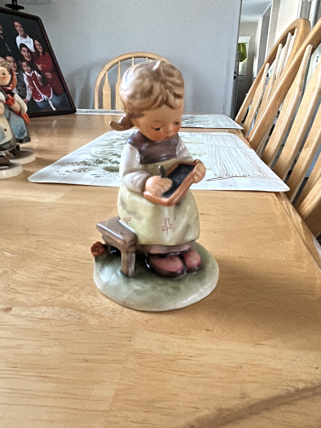 Porcelain figurine titled 'Busy Student' by M.I. Hummel