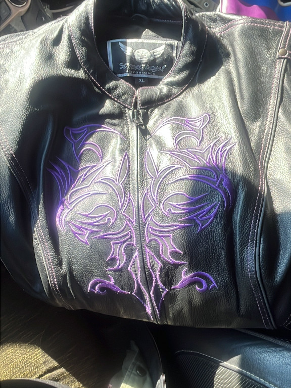 Black leather motorcycle jacket with purple embroidery by Milwaukee Leather